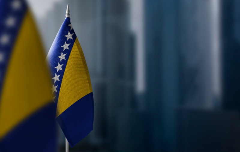 Small flags of Bosnia and Herzegovina on a blurry background of the city