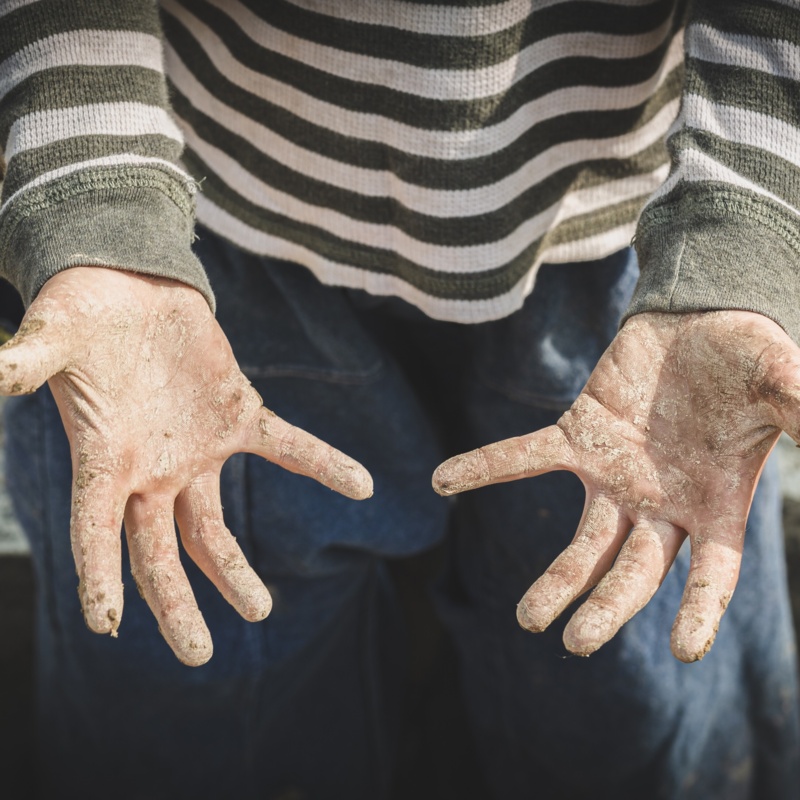 Stained hands are forced to work. The concept of anti-child labor. The abuse of labor. The oppression or intimidation of forced labor among children.